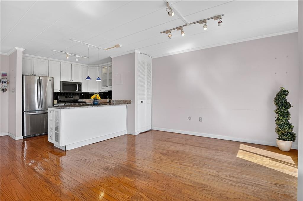 5 Bayard Road, Unit 913 Pittsburgh, PA 15213 - Photo 9 of 27 From the dining area, enjoy an uninterrupted view of the open-concept layout, where the sleek kitchen flows effortlessly into the spacious living room—creating the perfect for entertaining or relaxing at home.