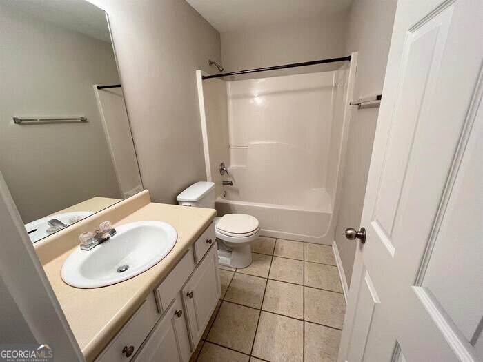 879 Langston Trace Stone Mountain, GA 30083 - Photo 12 of 16 a bathroom with a sink a toilet and shower