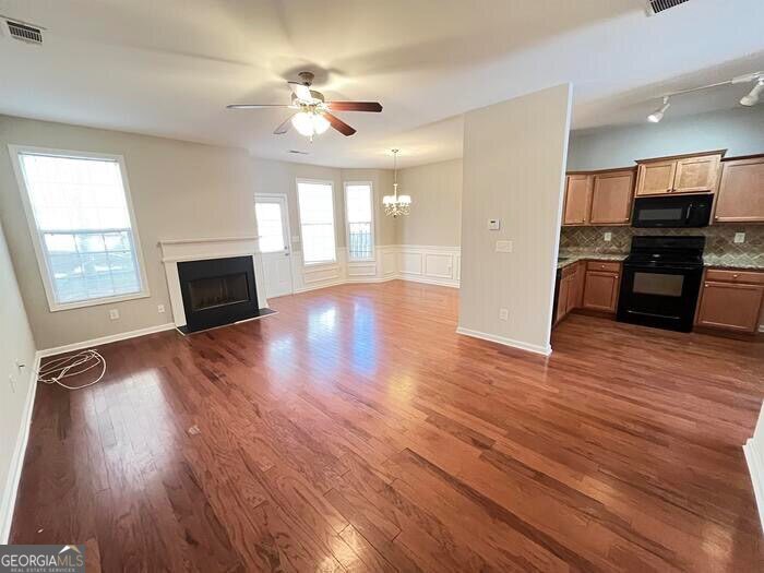 879 Langston Trace Stone Mountain, GA 30083 - Photo 4 of 16 a view of a livingroom with furniture hardwood floor and a ceiling fan