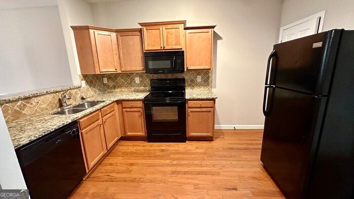 879 Langston Trace Stone Mountain, GA 30083 - Photo 5 of 16 a kitchen with stainless steel appliances granite countertop a refrigerator stove and microwave