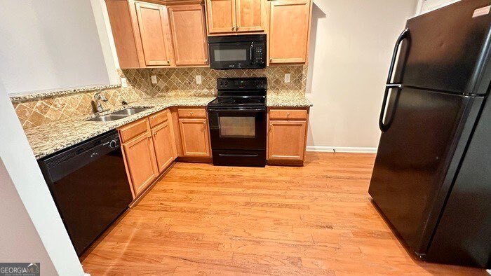 879 Langston Trace Stone Mountain, GA 30083 - Photo 6 of 16 a kitchen with stainless steel appliances granite countertop a refrigerator and a sink