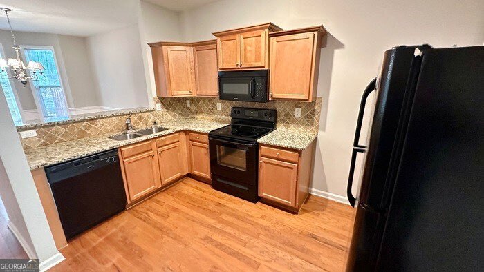 879 Langston Trace Stone Mountain, GA 30083 - Photo 7 of 16 a kitchen with stainless steel appliances granite countertop a refrigerator stove and sink