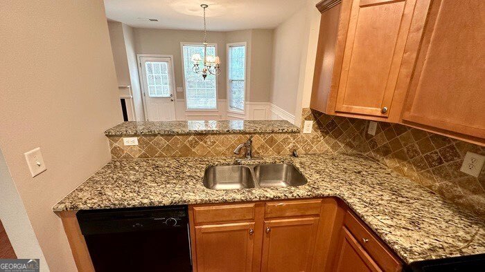 879 Langston Trace Stone Mountain, GA 30083 - Photo 10 of 16 a kitchen with granite countertop sink and cabinets
