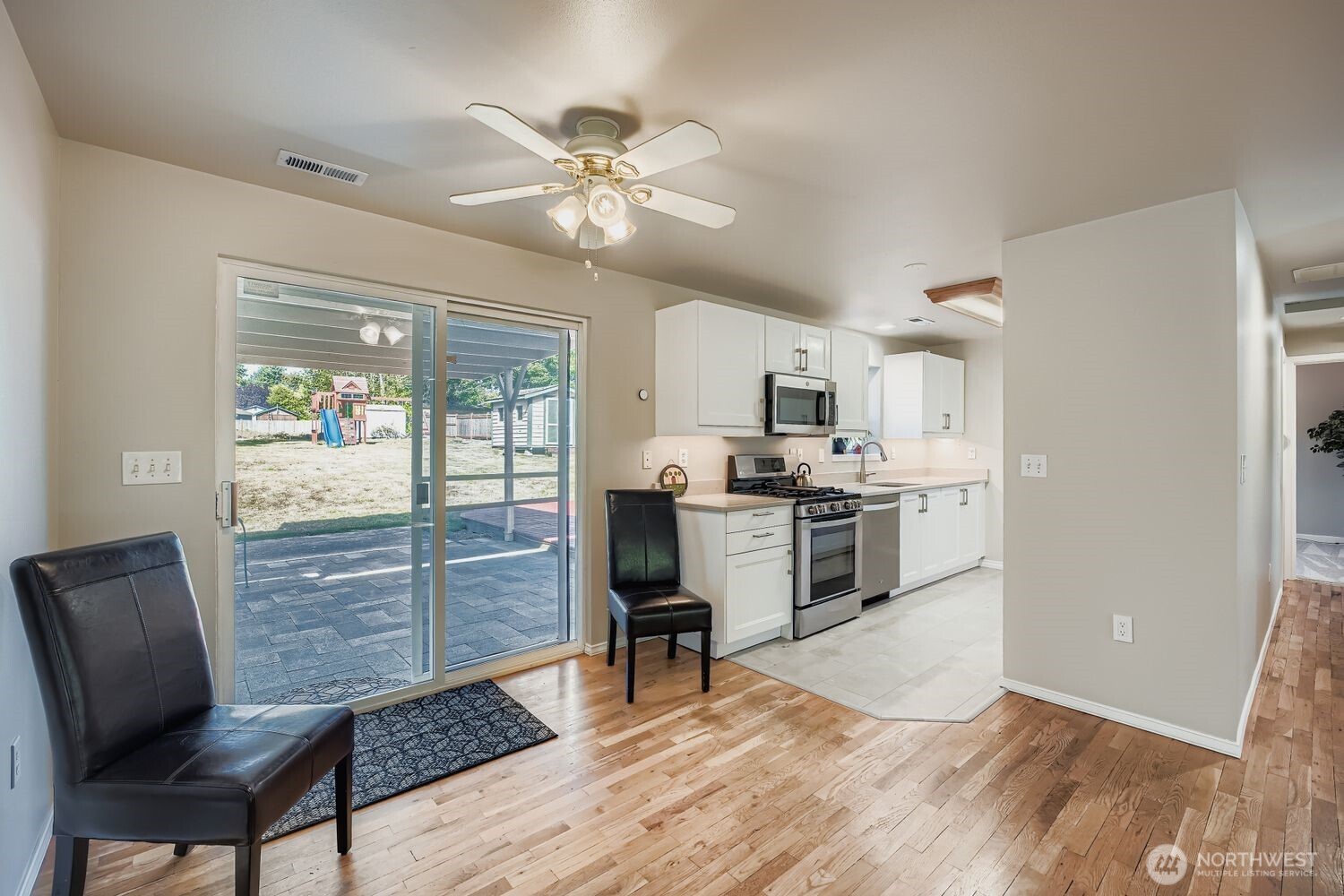 22408 Meridian Avenue South Bothell, WA 98021 - Photo 7 of 28 a view of kitchen with sink refrigerator dining table and chairs