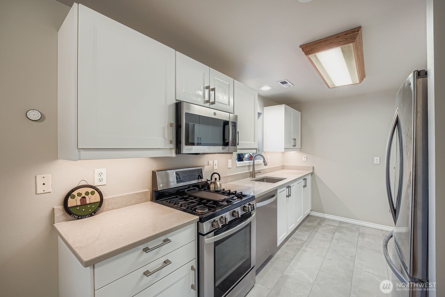 22408 Meridian Avenue South Bothell, WA 98021 - Photo 8 of 28 a kitchen with stainless steel appliances a stove microwave and a refrigerator
