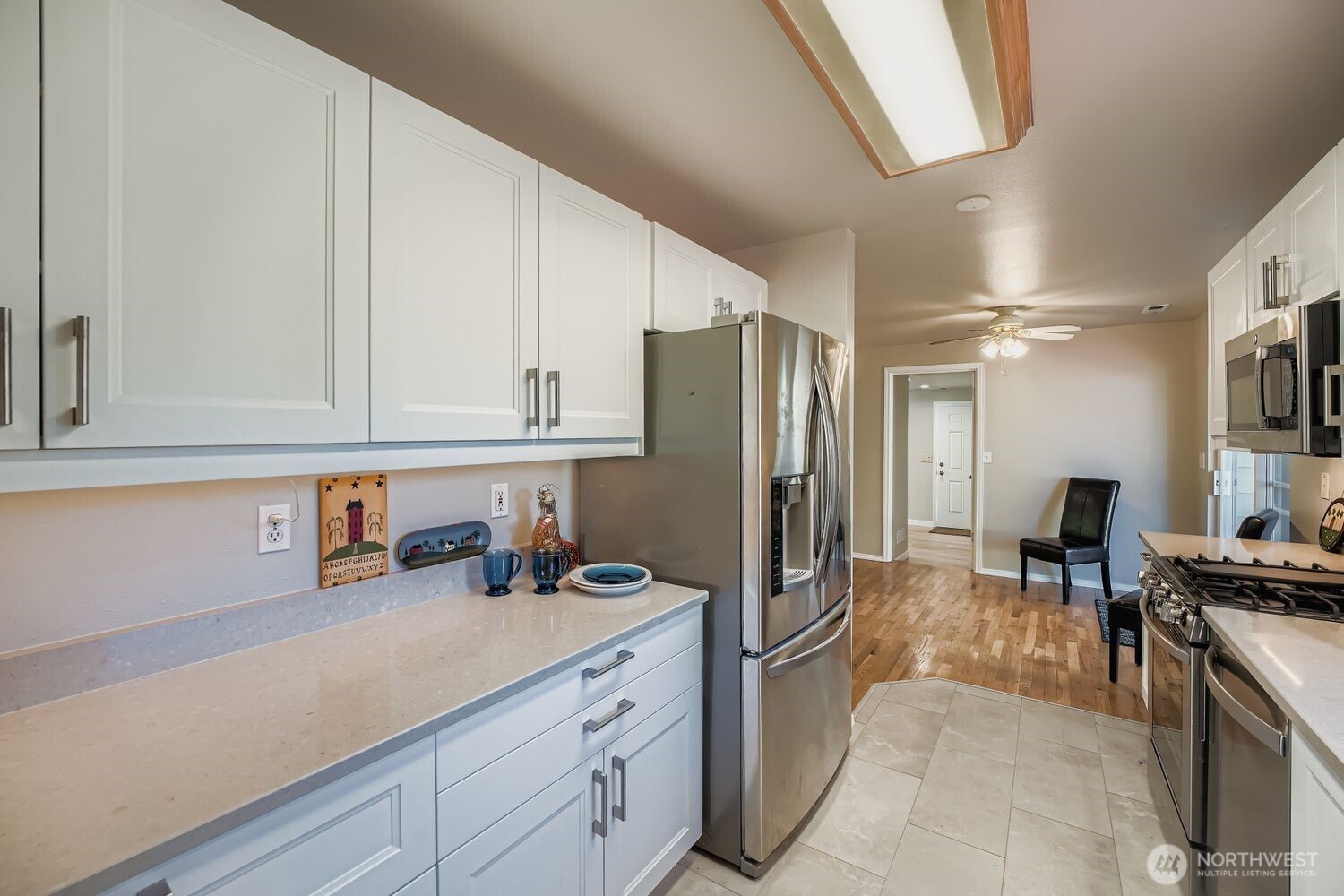 22408 Meridian Avenue South Bothell, WA 98021 - Photo 10 of 28 a kitchen with stainless steel appliances a refrigerator sink and cabinets