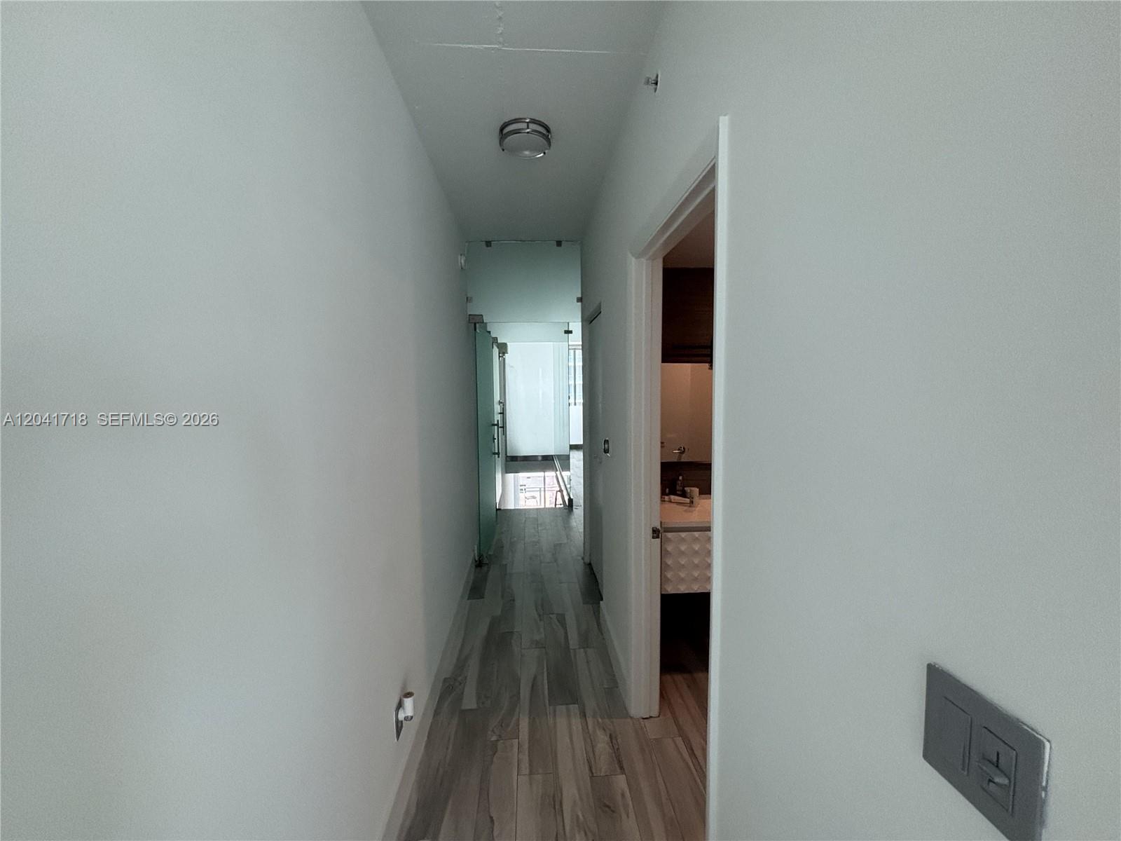 690 Southwest 1st Court, Unit 2124 Miami, FL 33130 - Photo 16 of 20 a view of a hallway with wooden floor and staircase