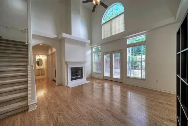 a view of a livingroom with wooden floor and a fireplace