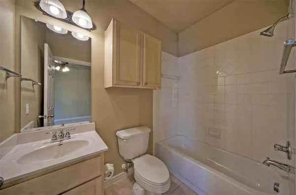 a bathroom with a sink a toilet a mirror and shower