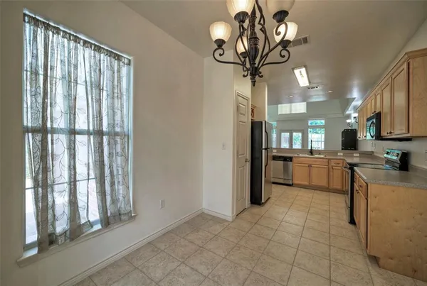 a view of a kitchen with furniture and a window