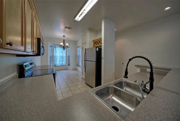 a kitchen with a refrigerator and a sink