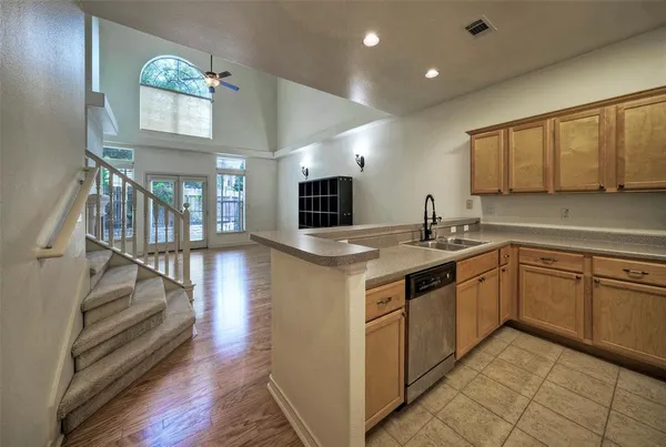 a kitchen with stainless steel appliances granite countertop a sink and cabinets