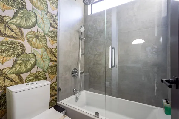 a bathroom with a bathtub and shower