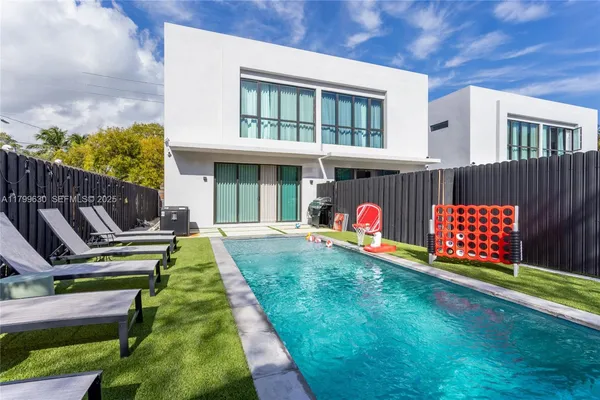 a view of swimming pool with lounge chairs