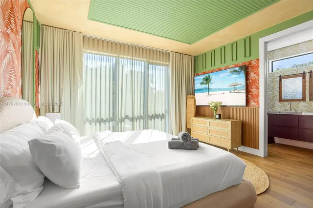 a bedroom with a bed and a large window