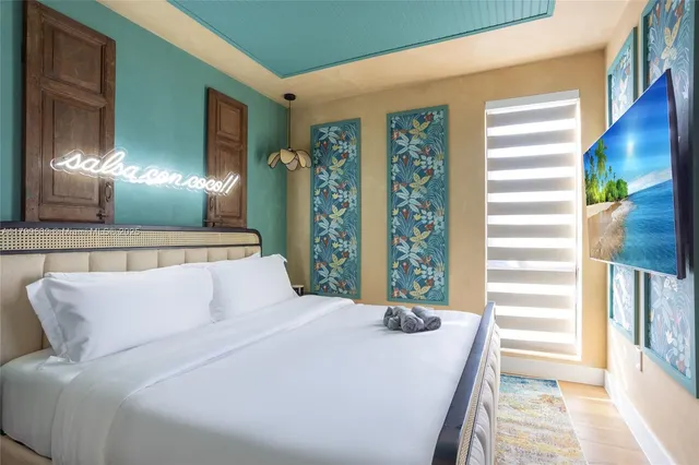 a bedroom with a bed and flowerpot with window