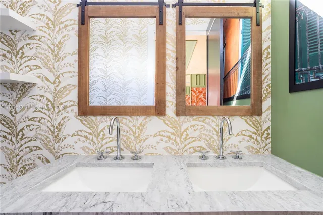 a white bath tub sitting in a bathroom next to a window