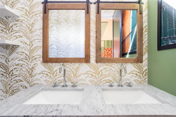a white bath tub sitting in a bathroom next to a window