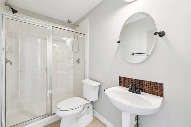 a bathroom with a sink toilet and shower