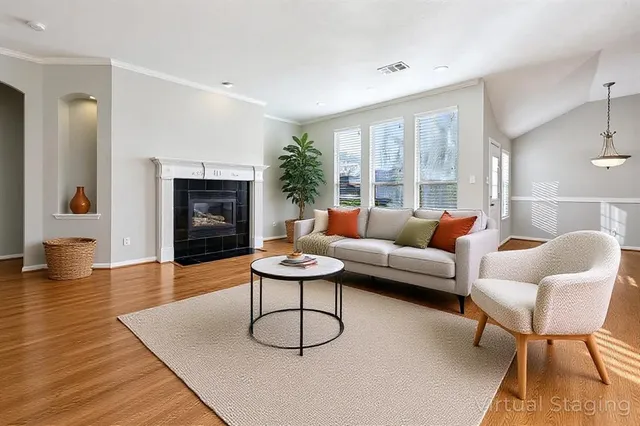 a living room with furniture and a fireplace