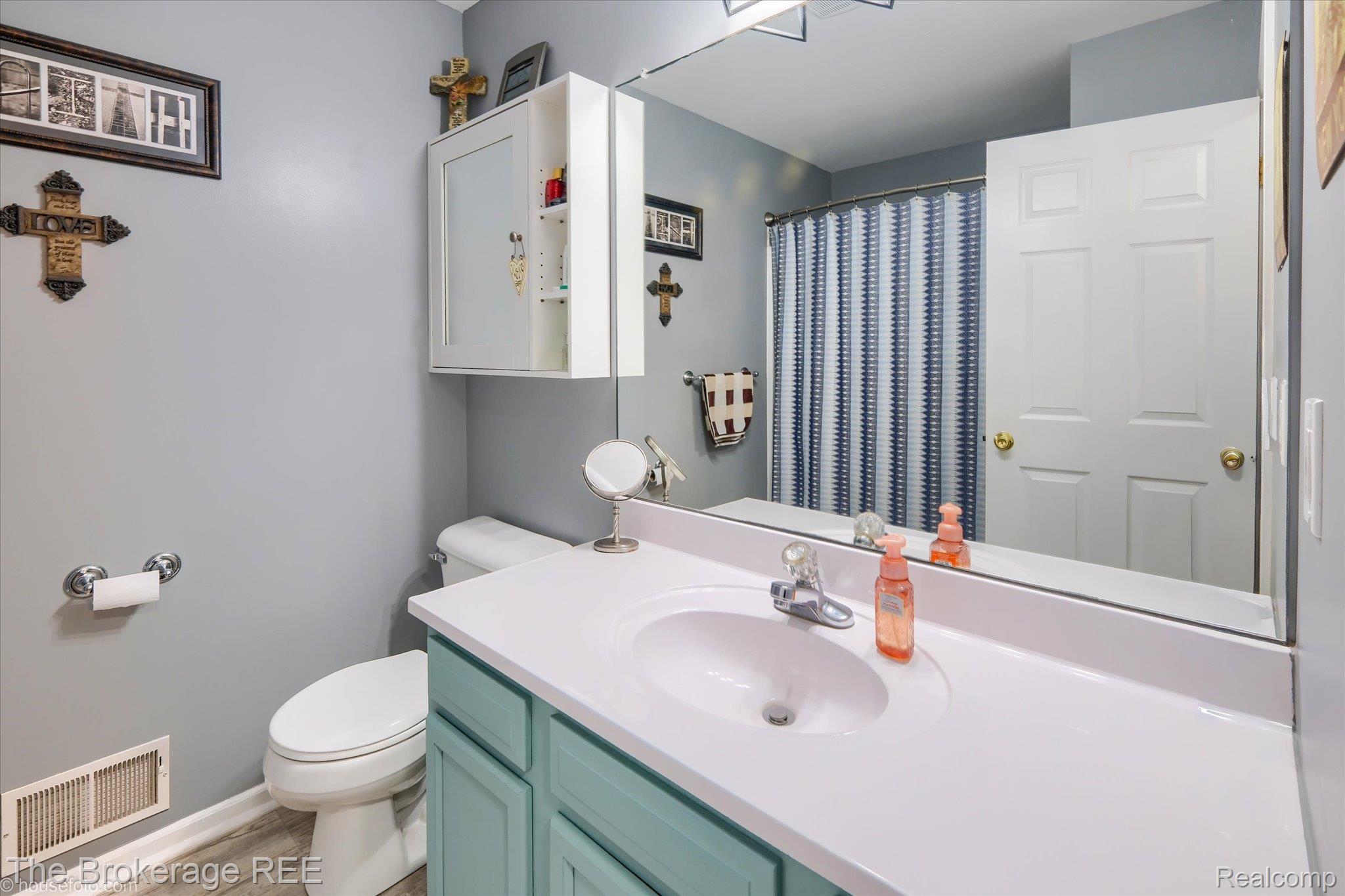 4432 North Belsay Road Flint, MI 48506 - Photo 60 of 79 Bathroom featuring a light blue vanity, white countertop with integrated sink, chrome faucet, and a large wall-mounted mirror