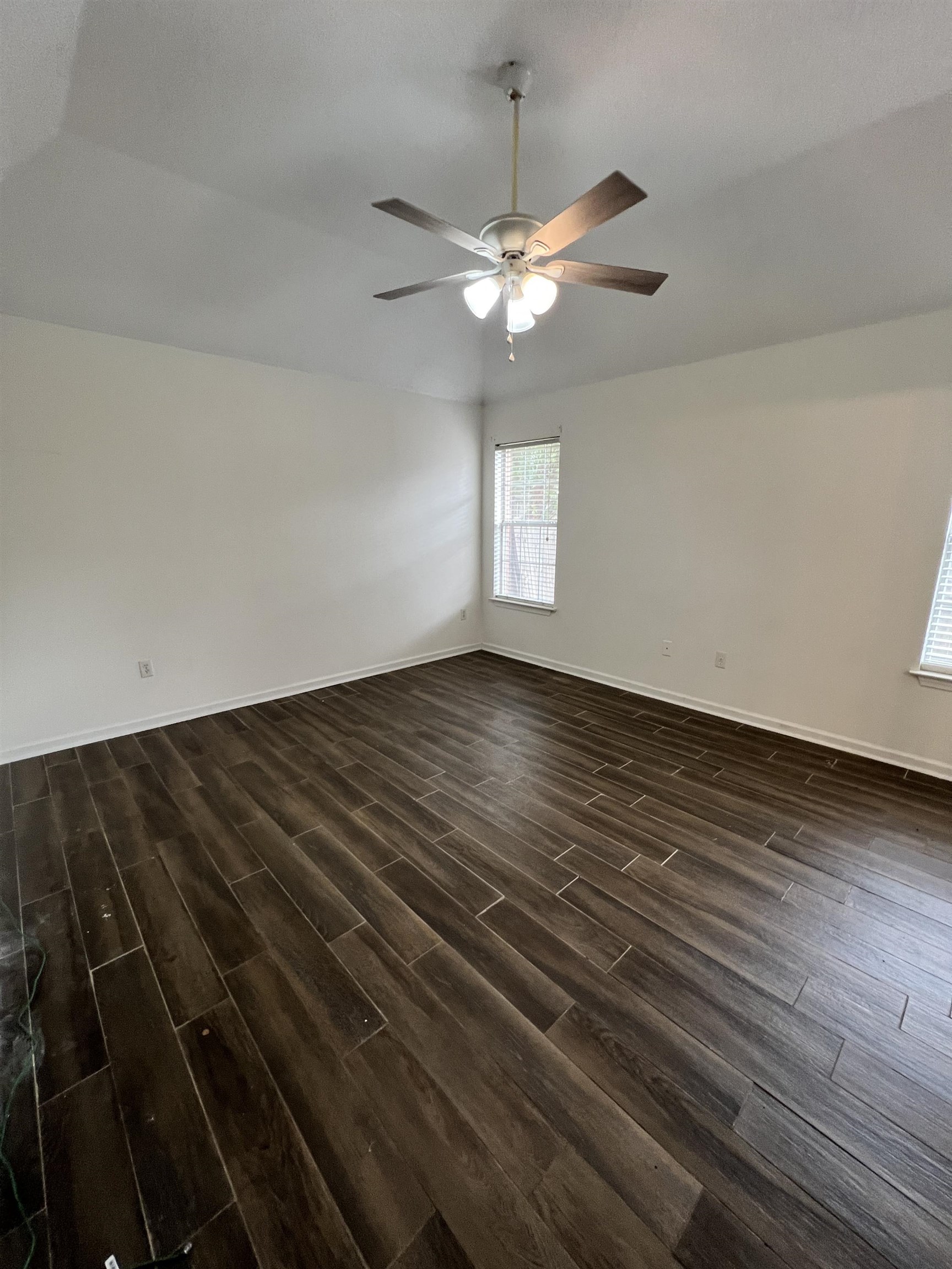 5760 Pecan Trace Memphis, TN 38135 - Photo 11 of 15 Empty room featuring dark wood finished floors and baseboards
