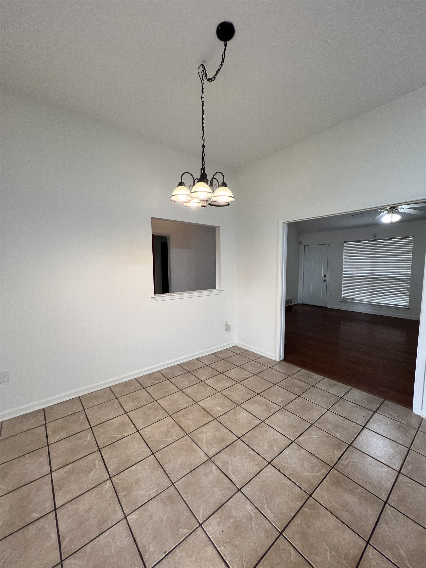 5760 Pecan Trace Memphis, TN 38135 - Photo 6 of 15 Tiled spare room featuring a chandelier and a ceiling fan