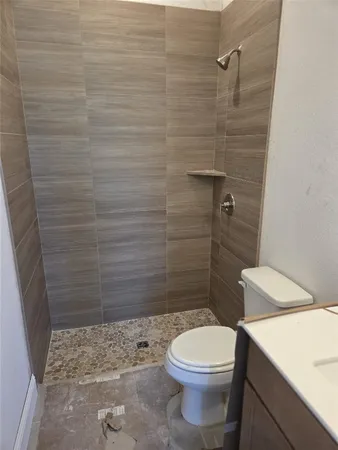 a bathroom with a toilet and a shower