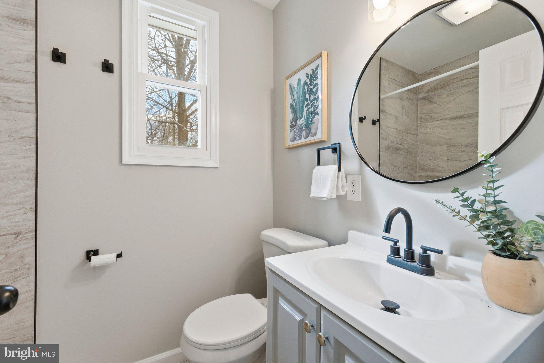 3802 Elby Court Silver Spring, MD 20906 - Photo 5 of 33 a bathroom with a sink mirror and toilet