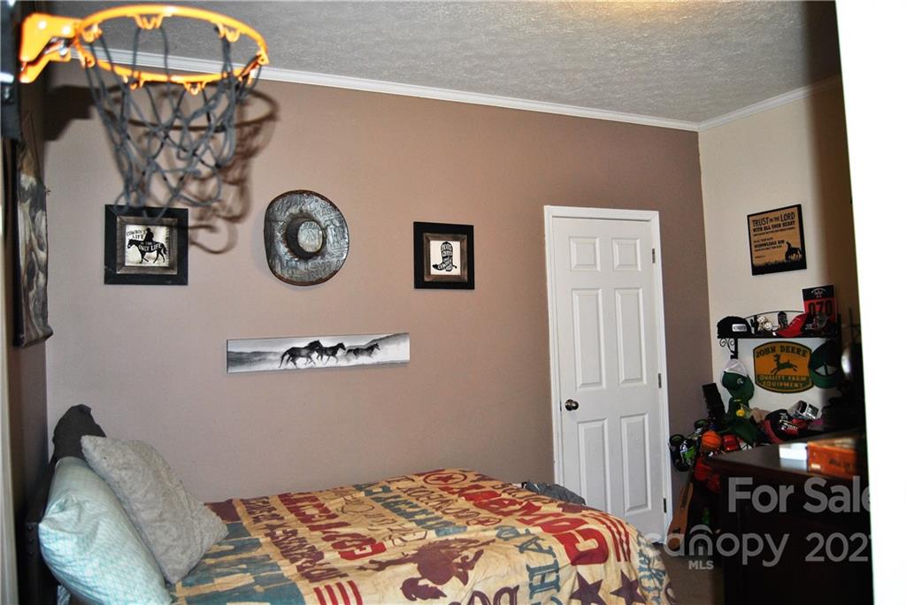 1208 Hammond Carnes Road Lancaster, SC 29720 - Photo 14 of 20 a bedroom with a bed and a chandelier