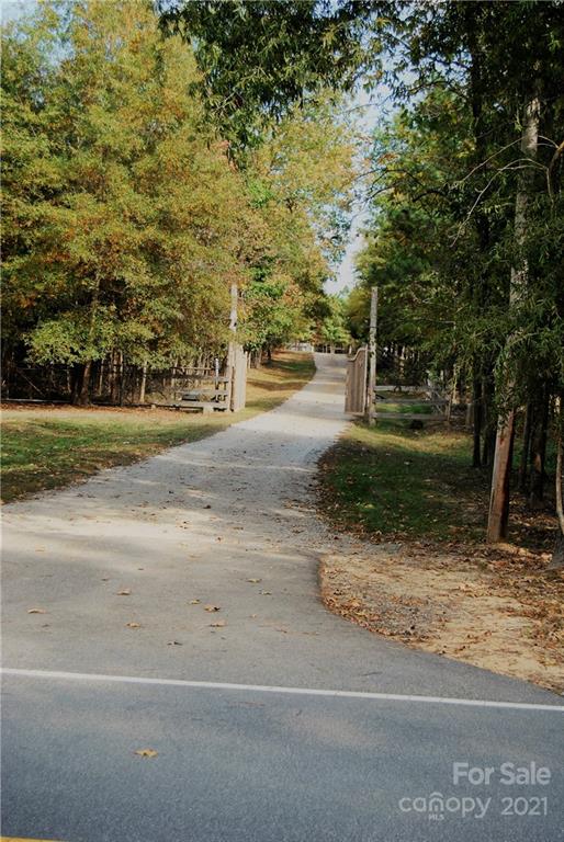1208 Hammond Carnes Road Lancaster, SC 29720 - Photo 3 of 20 a view of a yard with yellow lighting