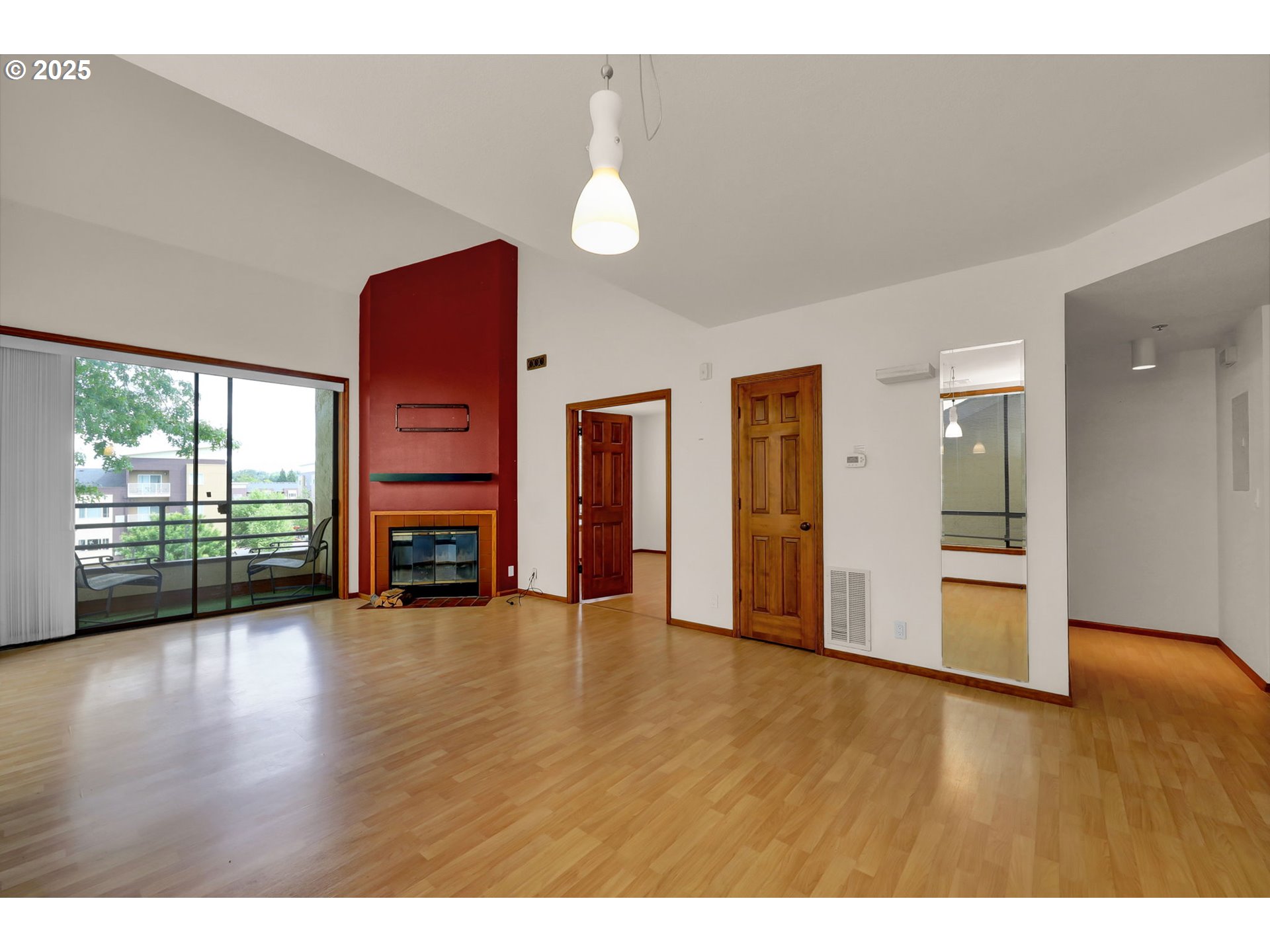 648 Wimbledon Court Eugene, OR 97401 - Photo 10 of 45 a view of an empty room with wooden floor fireplace and a window