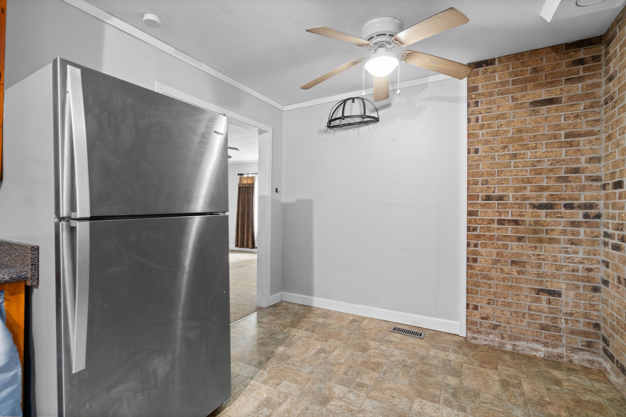 660 Palmyra Road Clarksville, TN 37040 - Photo 15 of 33 a view of a refrigerator in kitchen and an empty room