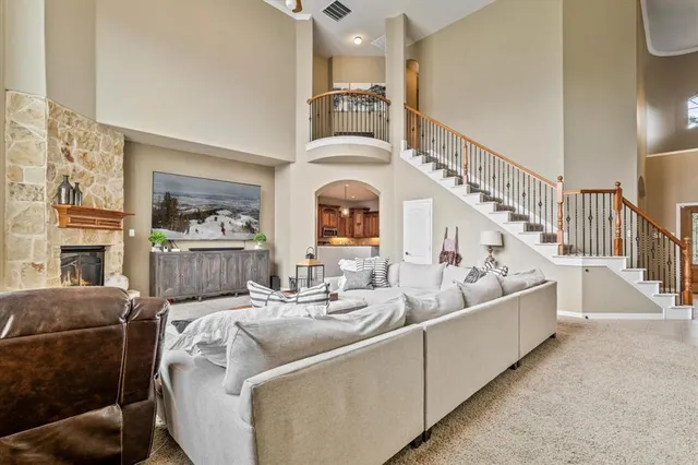 a living room with furniture fireplace and a rug