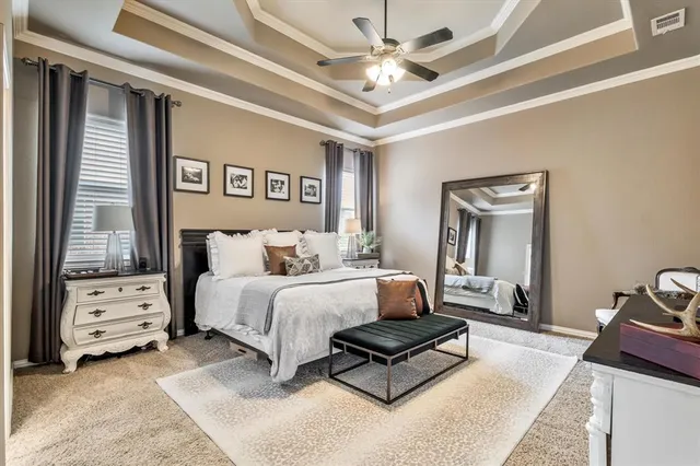 a spacious bedroom with a bed and a chandelier