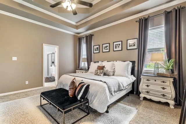 a spacious bedroom with a bed and a window