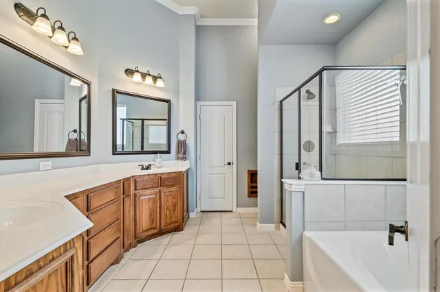 a spacious bathroom with a tub sink and mirror