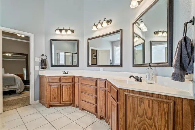 a spacious bathroom with a double vanity sink and a mirror