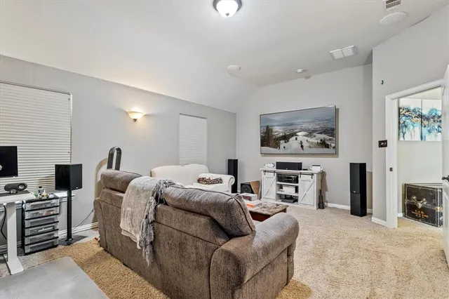 a bedroom with furniture and a flat screen tv