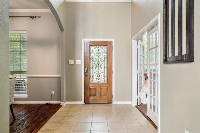 a view of an entryway with wooden floor and windows