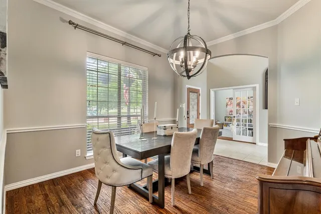 a view of a dining room with furniture wooden floor and chandelier