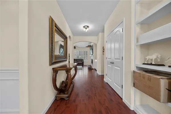 a view of a hallway with wooden floor windows and livingroom view