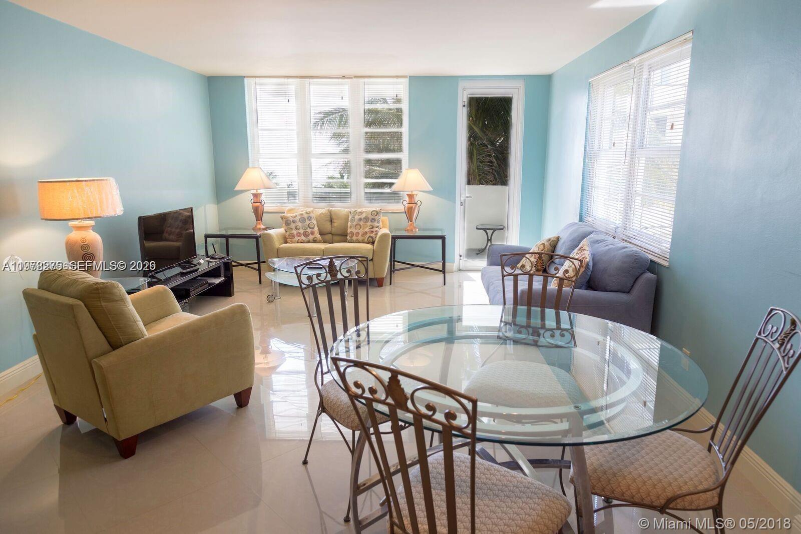100 Lincoln Road, Unit 521 Miami Beach, FL 33139 - Photo 2 of 9 a dining room with furniture and wooden floor