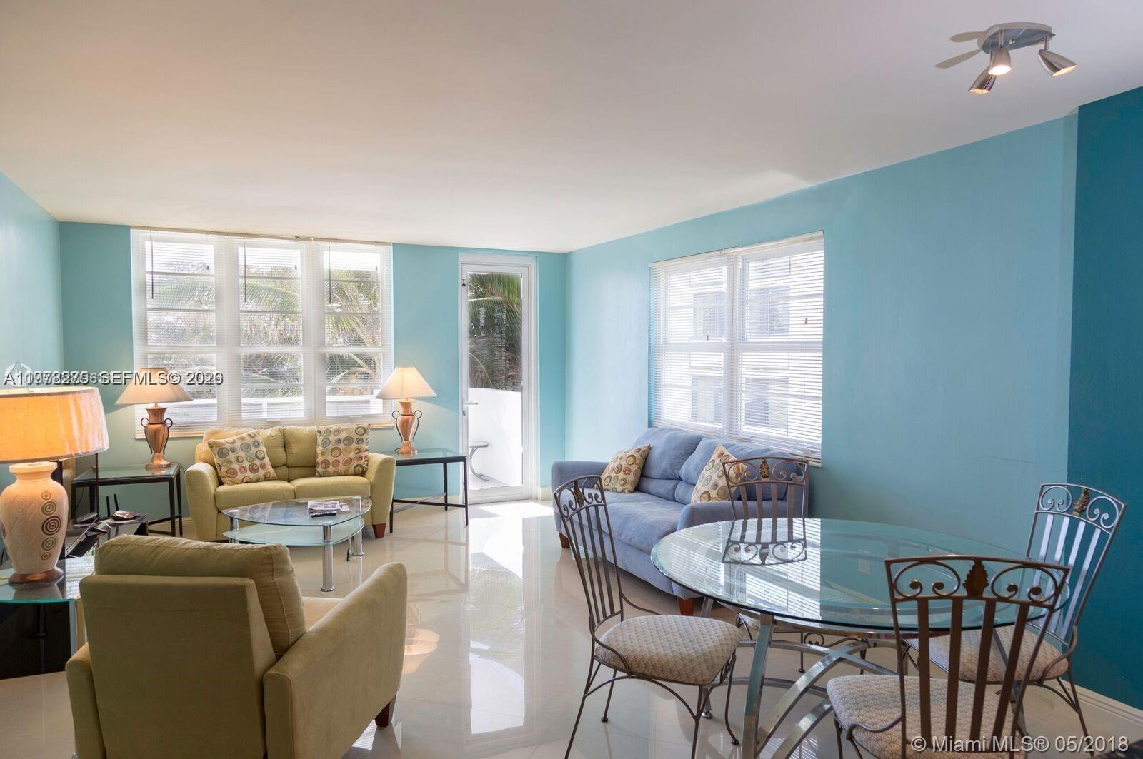 100 Lincoln Road, Unit 521 Miami Beach, FL 33139 - Photo 3 of 9 a living room with furniture and a floor to ceiling window