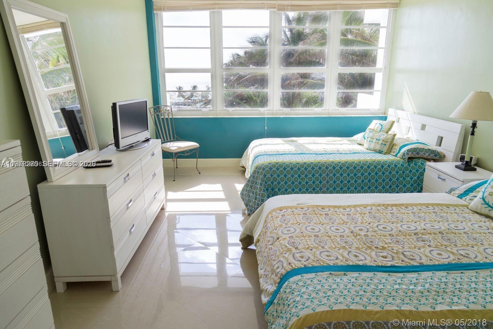 100 Lincoln Road, Unit 521 Miami Beach, FL 33139 - Photo 5 of 9 a bedroom with a bed and a window