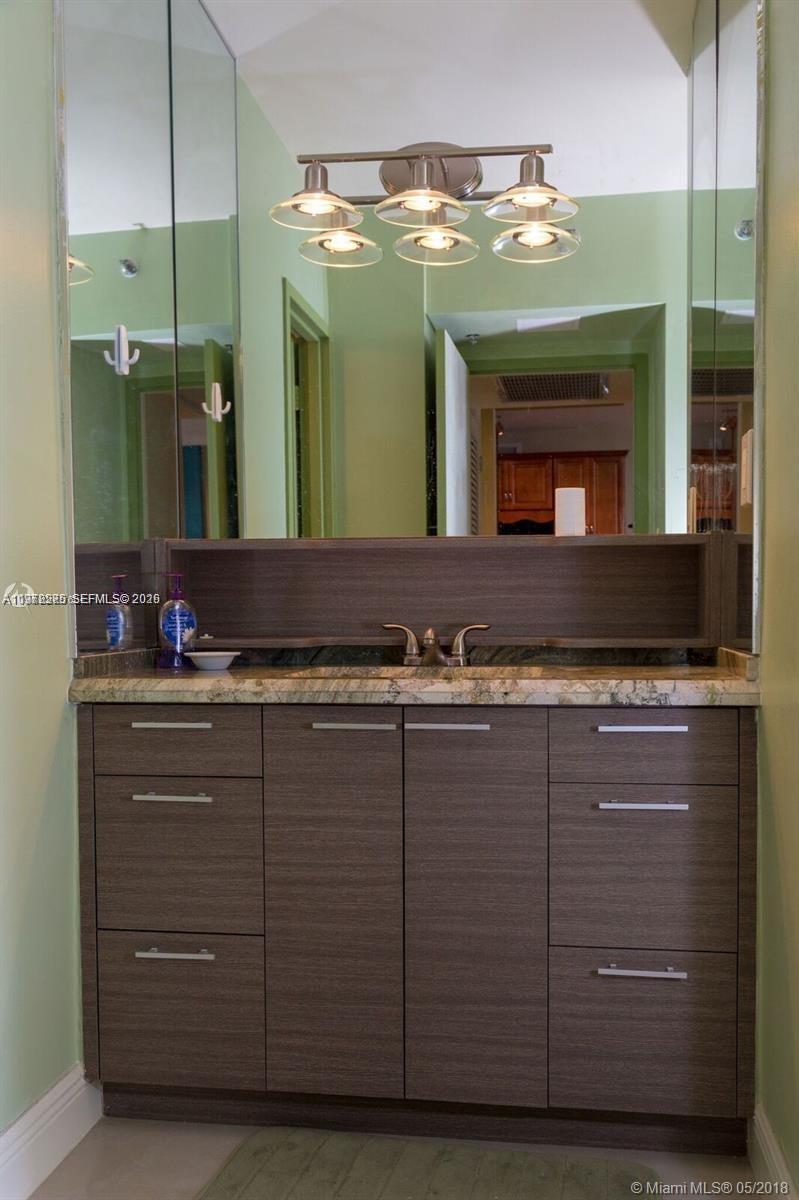 100 Lincoln Road, Unit 521 Miami Beach, FL 33139 - Photo 6 of 9 a bathroom with a double vanity sink and a large mirror
