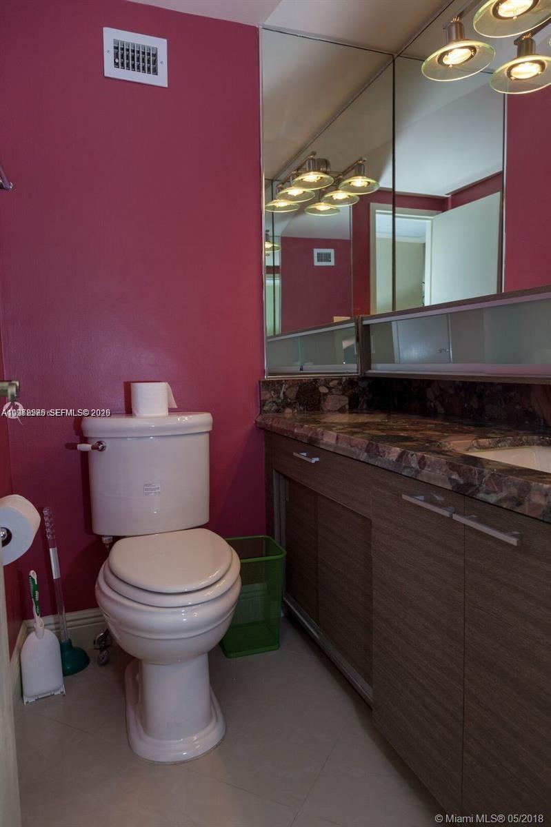100 Lincoln Road, Unit 521 Miami Beach, FL 33139 - Photo 7 of 9 a bathroom with a sink and a toilet