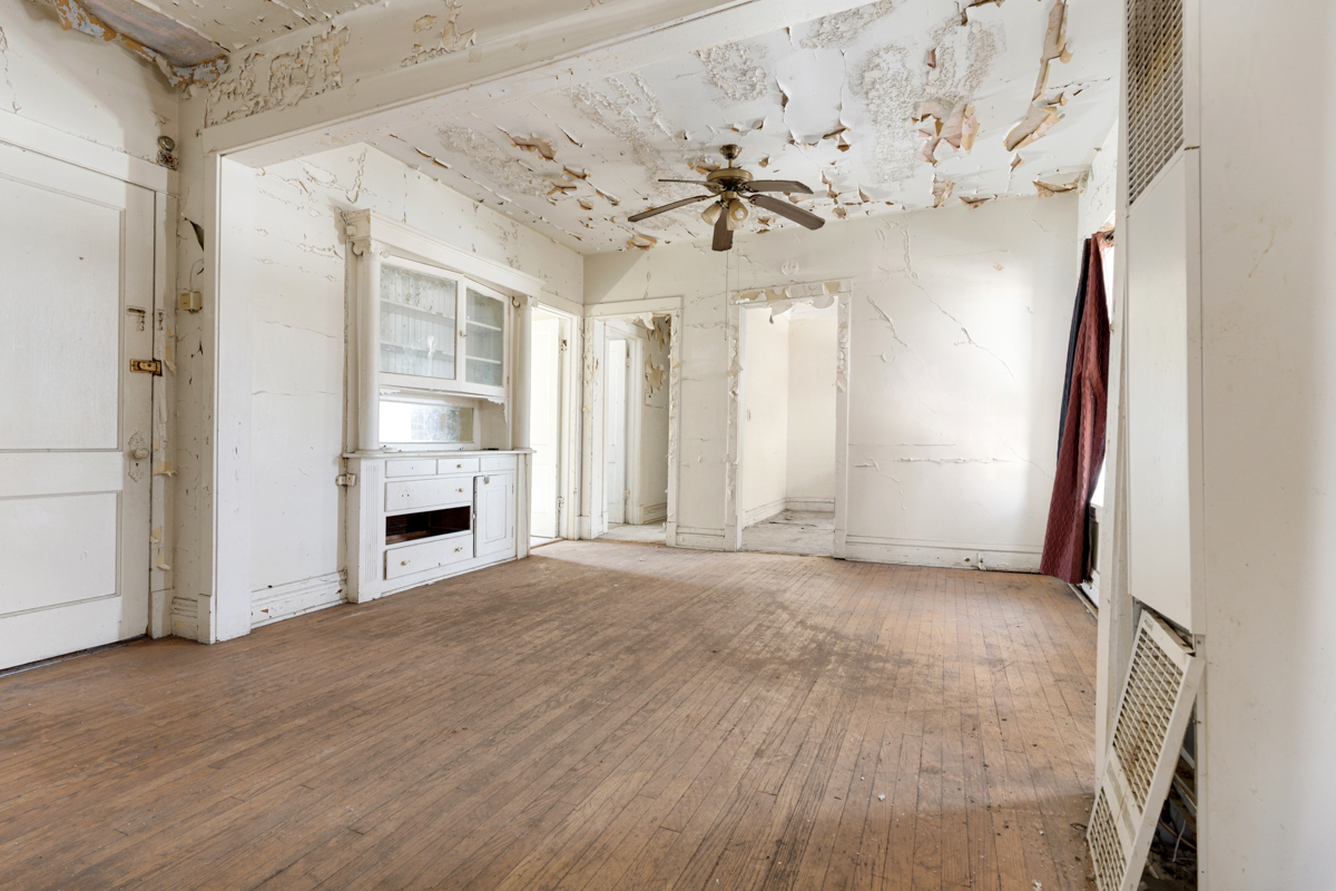 1457 West Marquette Road Chicago, IL 60636 - Photo 16 of 26 a view of a livingroom with a fireplace a chandelier and wooden floor