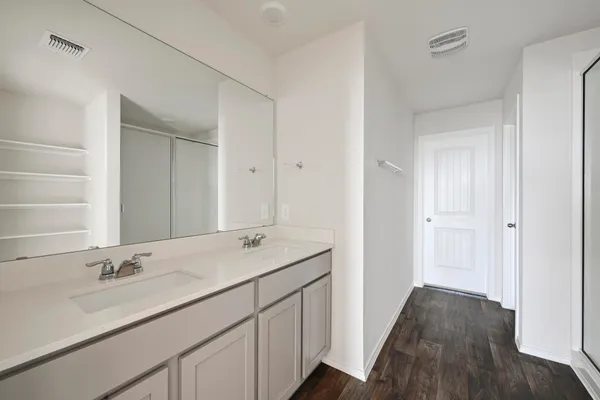 a bathroom with a sink double vanity and a mirror
