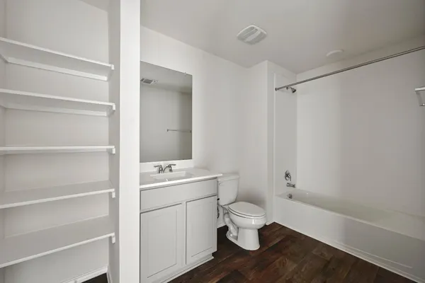 a bathroom with a sink a toilet a shower and a mirror